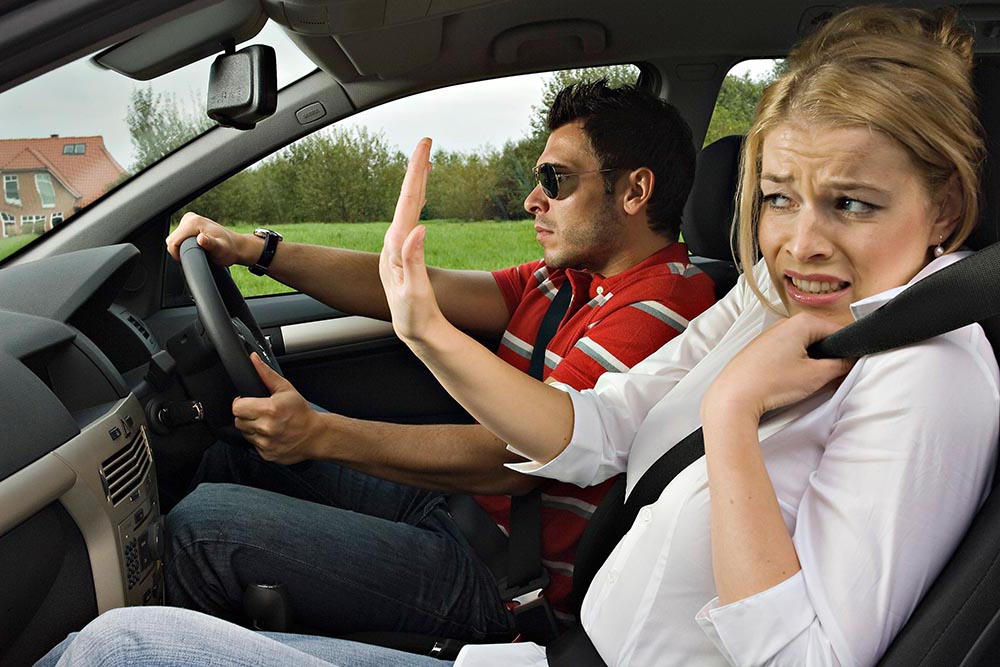 He is driving, she is anxious