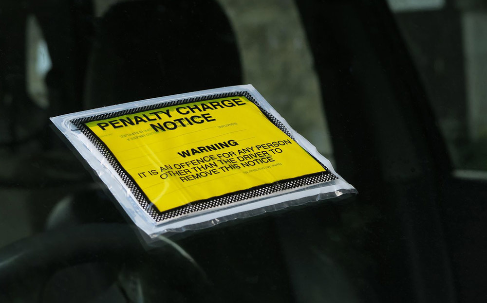 Penalty charge notice on car windscreen. Sunday Times Driving Reader Letters: bicycle tax, diesel cars and stealthy road signs