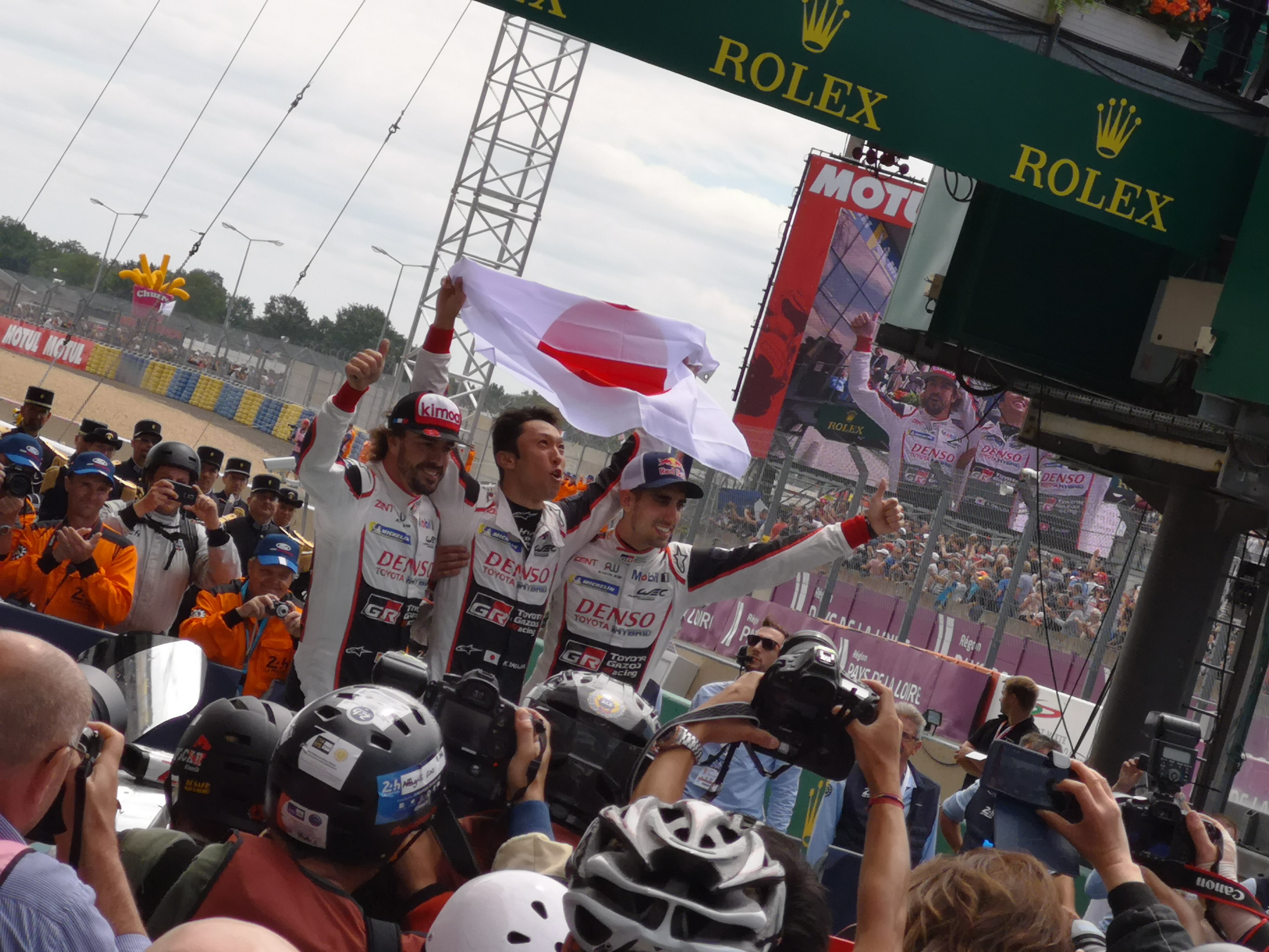 2018 Le Mans 24 Hours - post-race atmosphere in pitlane and podium - Fernando Alonso, Kajuki Nakajima, Sebastien Buemi