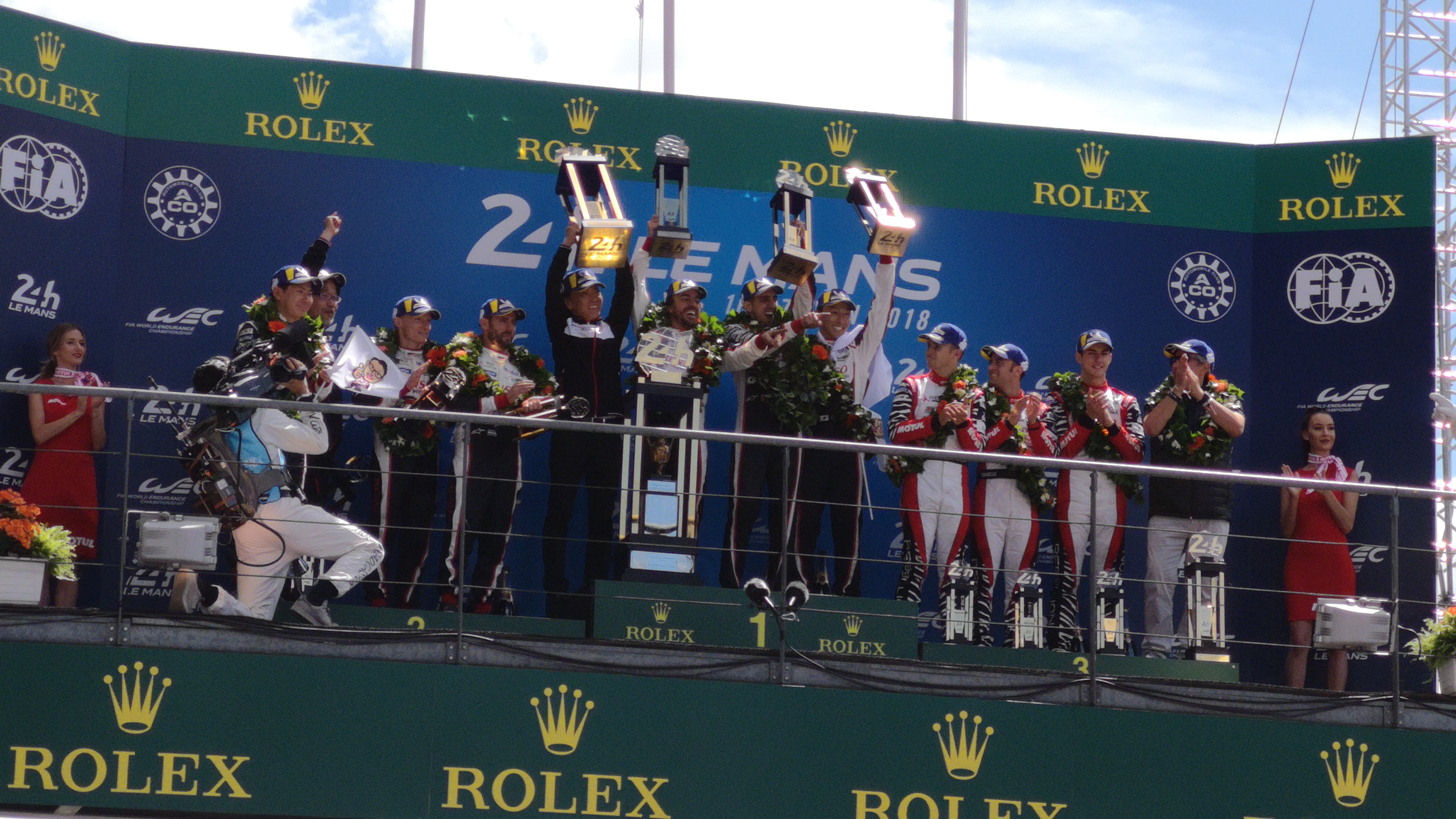 2018 Le Mans 24 Hours - post-race atmosphere in pitlane and podium - Fernando Alonso, Kajuki Nakajima, Sebastien Buemi